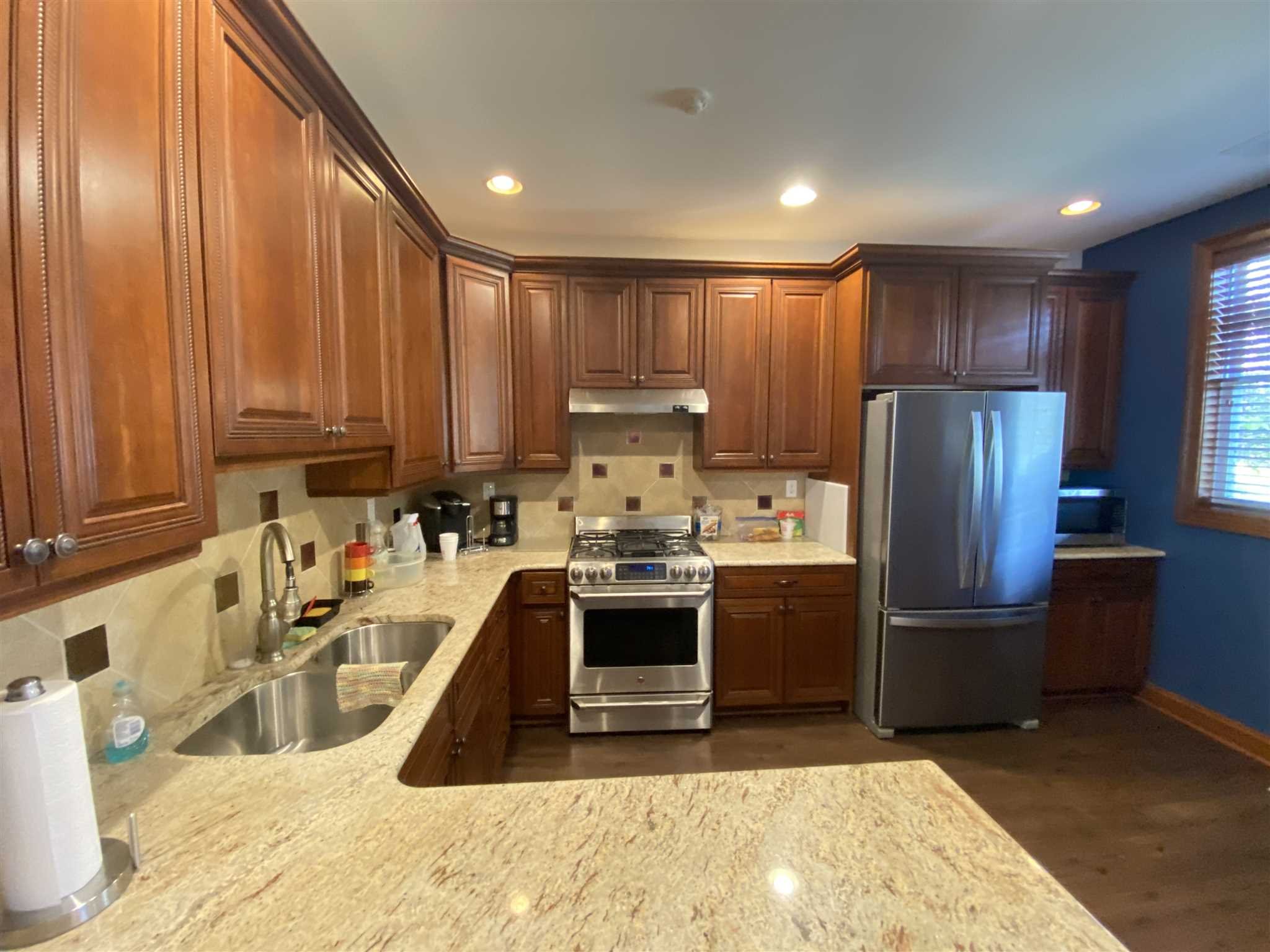 643 Regency Drive Fishkill, NY 12524 - Photo 29 of 37 a kitchen with stainless steel appliances granite countertop a refrigerator sink and cabinets