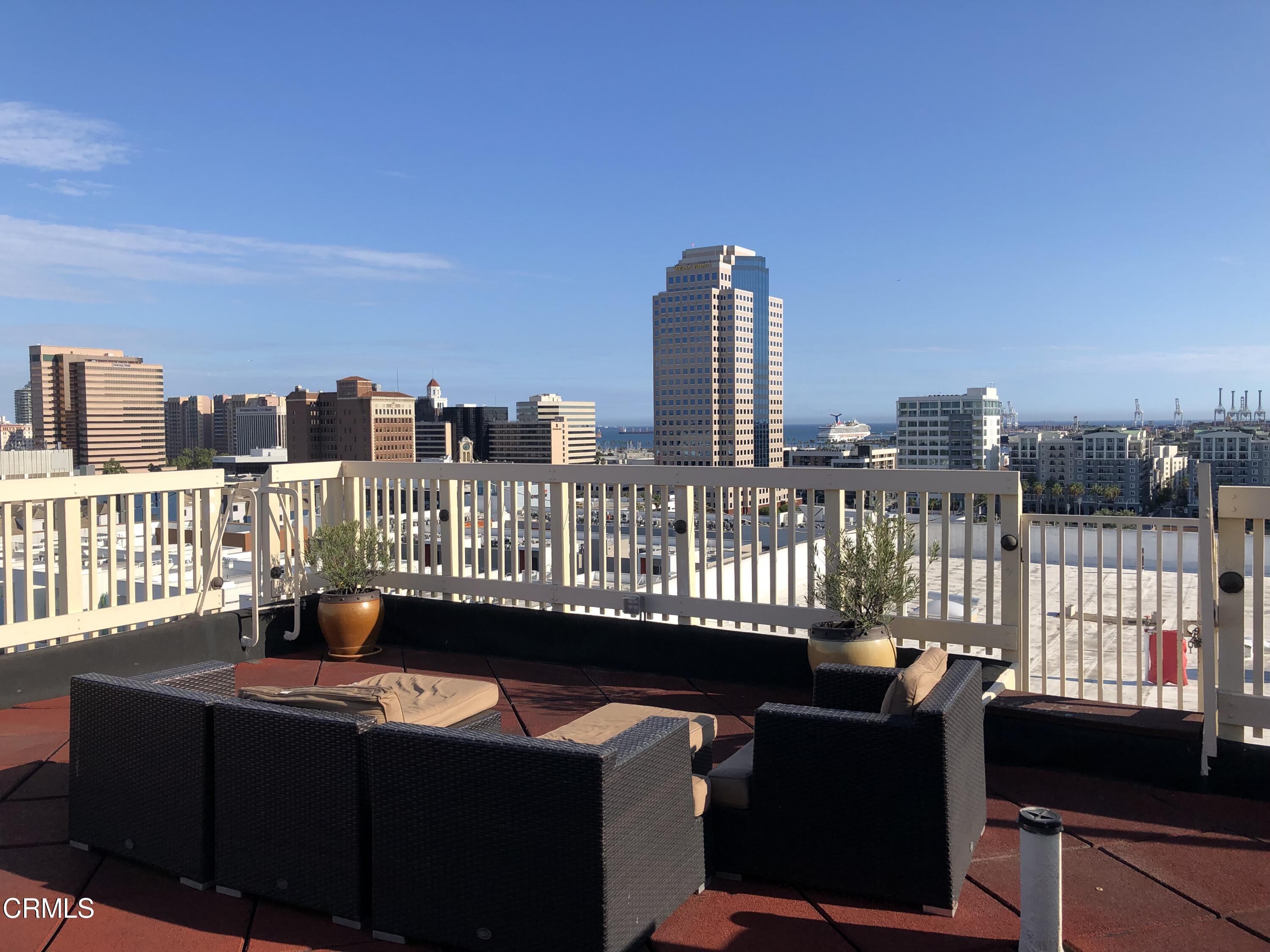 315 West 3rd Street, Unit 301 Long Beach, CA 90802 - Photo 13 of 15 a view of a balcony with two chairs and a table