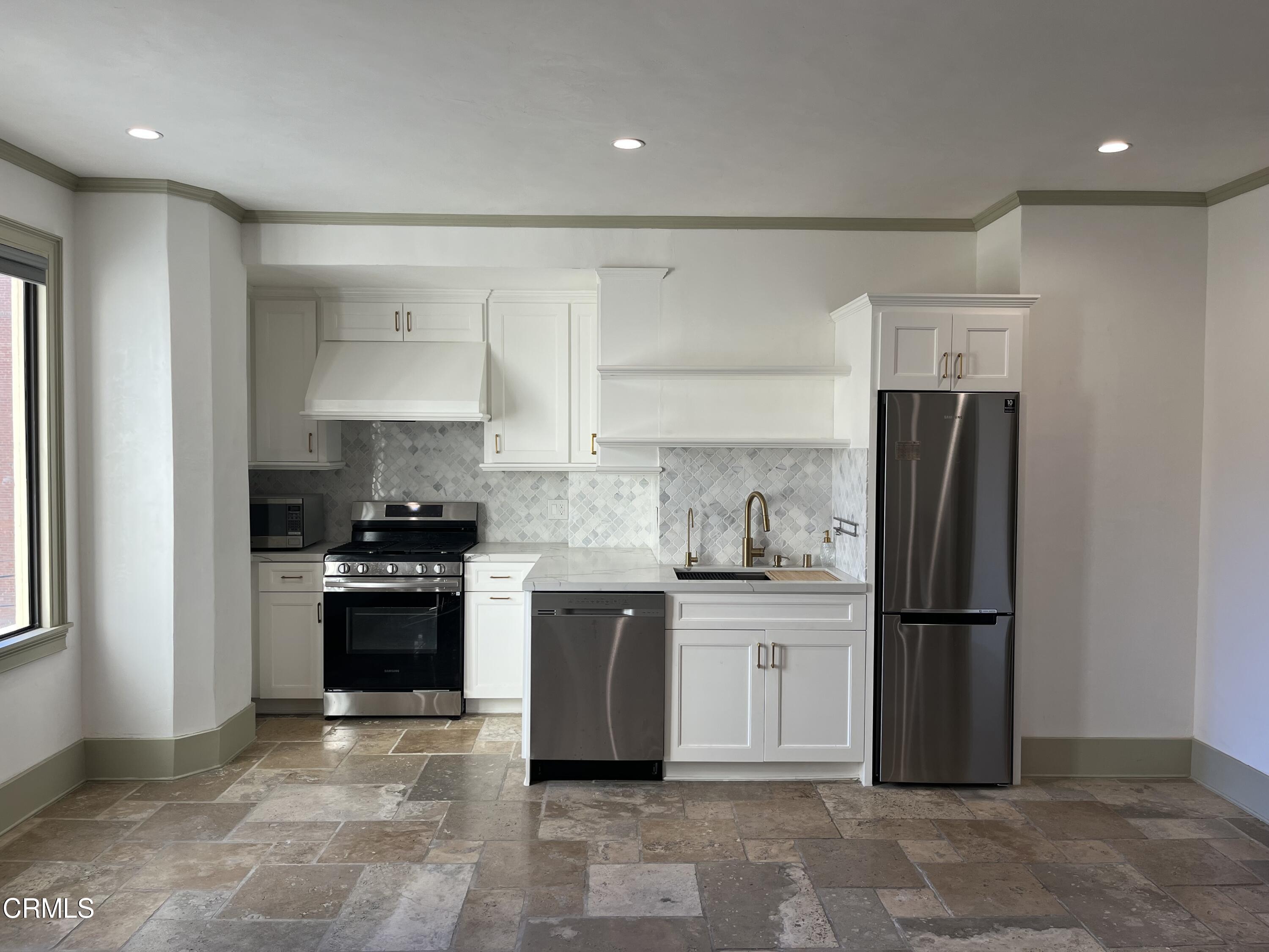 315 West 3rd Street, Unit 301 Long Beach, CA 90802 - Photo 4 of 15 a kitchen with granite countertop a refrigerator stove top oven and sink