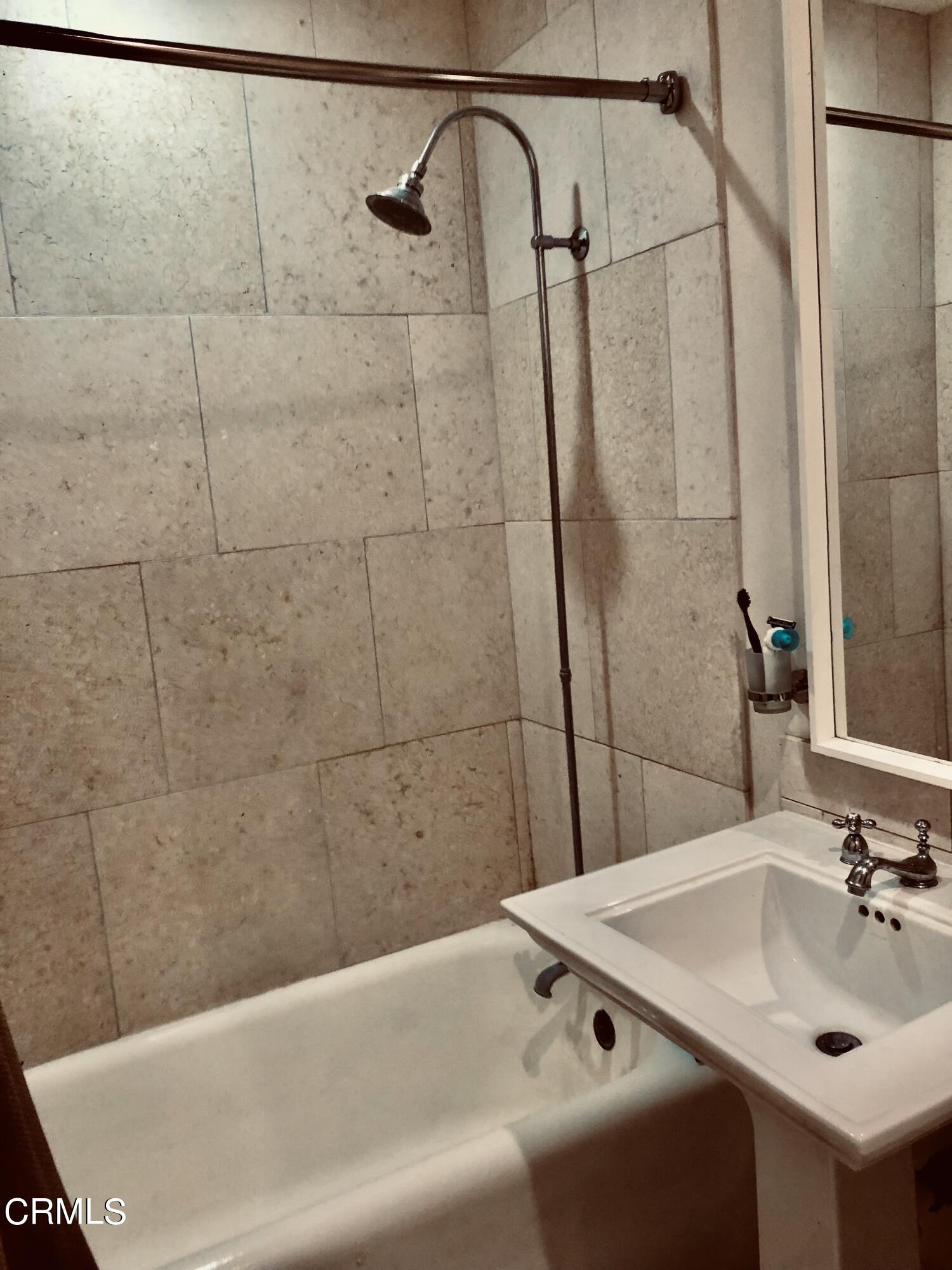 315 West 3rd Street, Unit 301 Long Beach, CA 90802 - Photo 7 of 15 a bathroom with a sink and shower