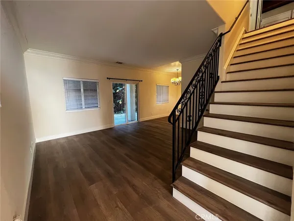 a view of entryway with wooden floor and stairs