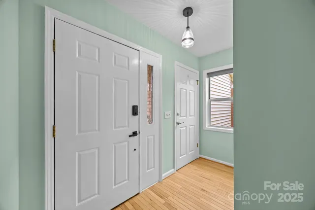 a view of a room with a chandelier fan