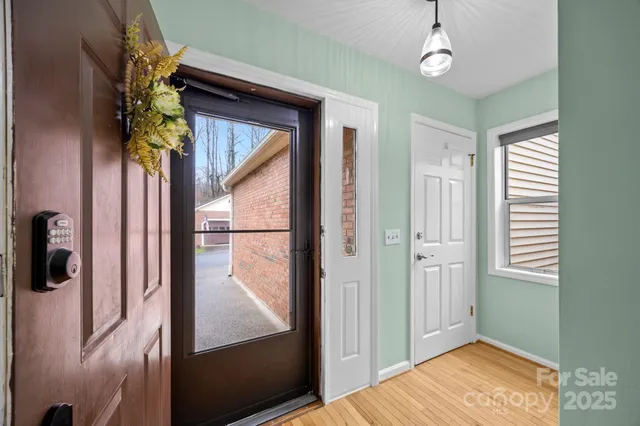 a view of entryway with a front door and wooden floor