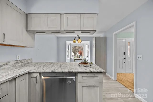 a kitchen with stainless steel appliances granite countertop a sink stove and cabinets