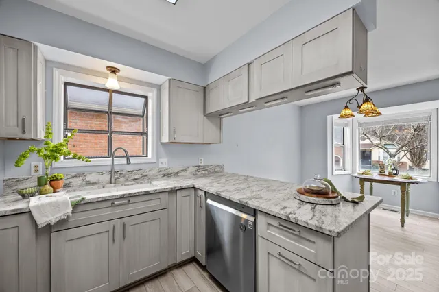 a kitchen with stainless steel appliances granite countertop a sink stove and cabinets