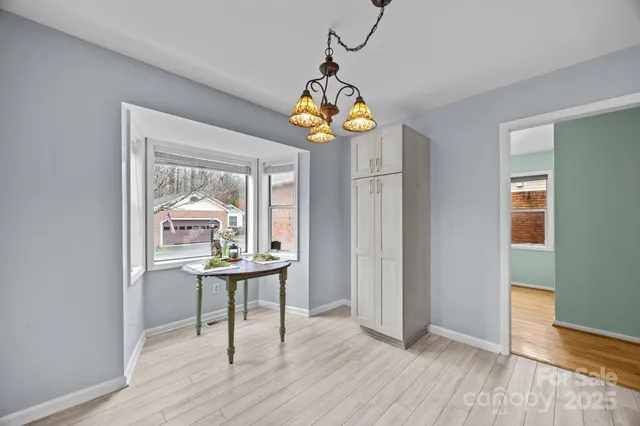 a view of a dining room with furniture wooden floor and a window