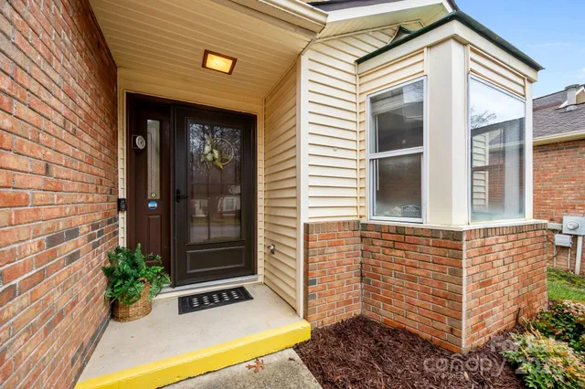 a view of house with potted plants
