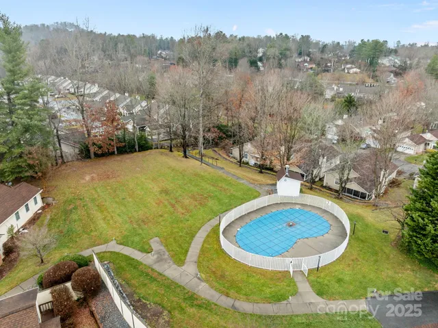 a view of a swimming pool with a yard