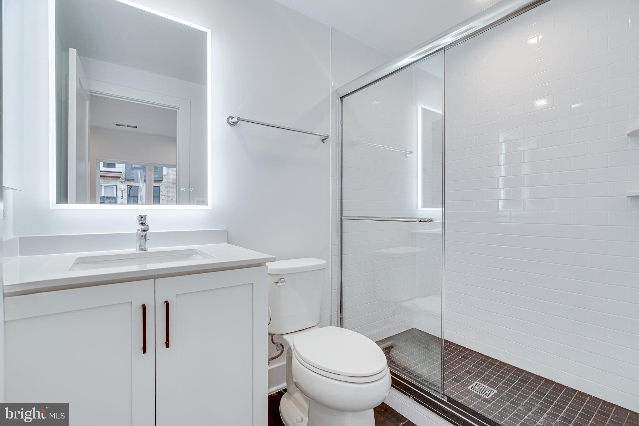 2070 Tysons Ridgeline Road Falls Church, VA 22043 - Photo 12 of 57 a bathroom with a granite countertop sink toilet and shower