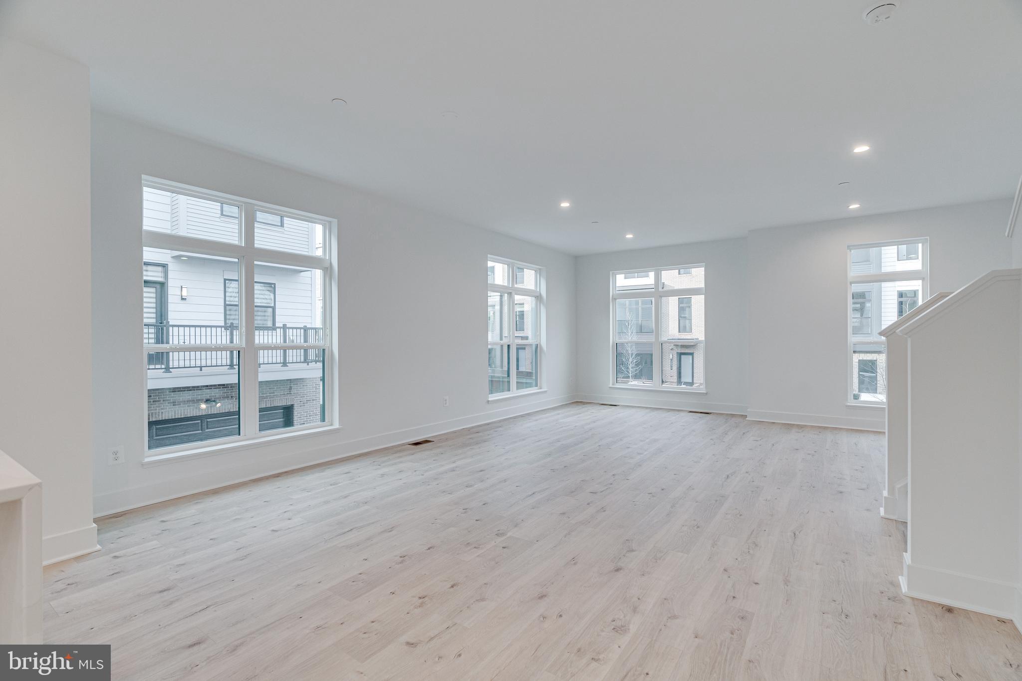 2070 Tysons Ridgeline Road Falls Church, VA 22043 - Photo 14 of 57 a view of an empty room with a window and wooden floor