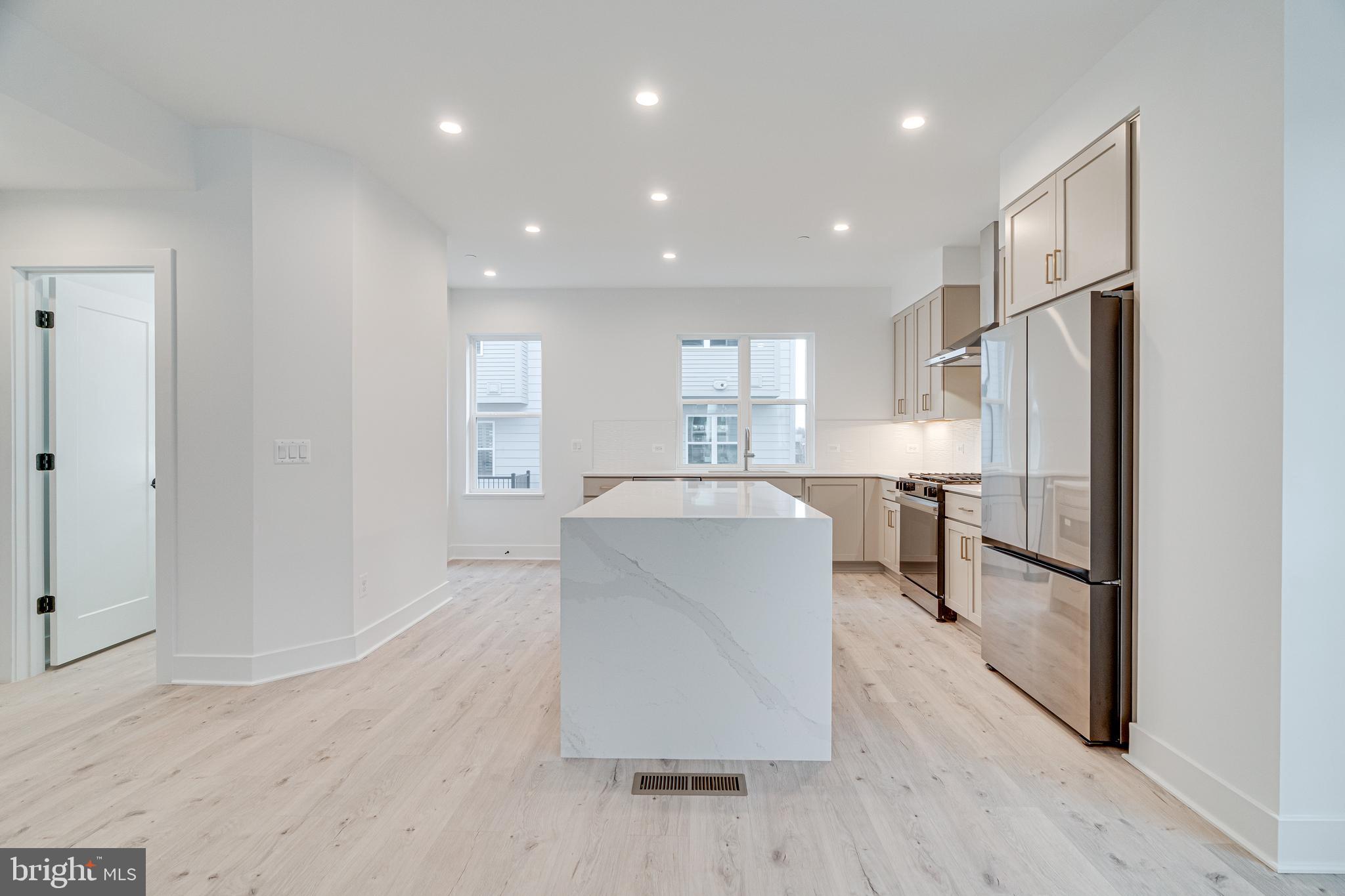 2070 Tysons Ridgeline Road Falls Church, VA 22043 - Photo 20 of 57 a living room with stainless steel appliances furniture refrigerator and wooden floor