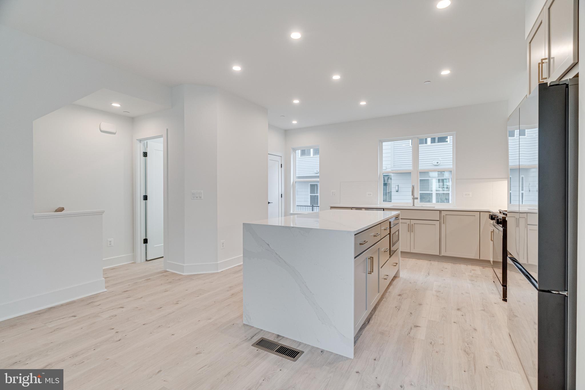 2070 Tysons Ridgeline Road Falls Church, VA 22043 - Photo 21 of 57 a large kitchen with kitchen island a large counter top space a sink stainless steel appliances and cabinets