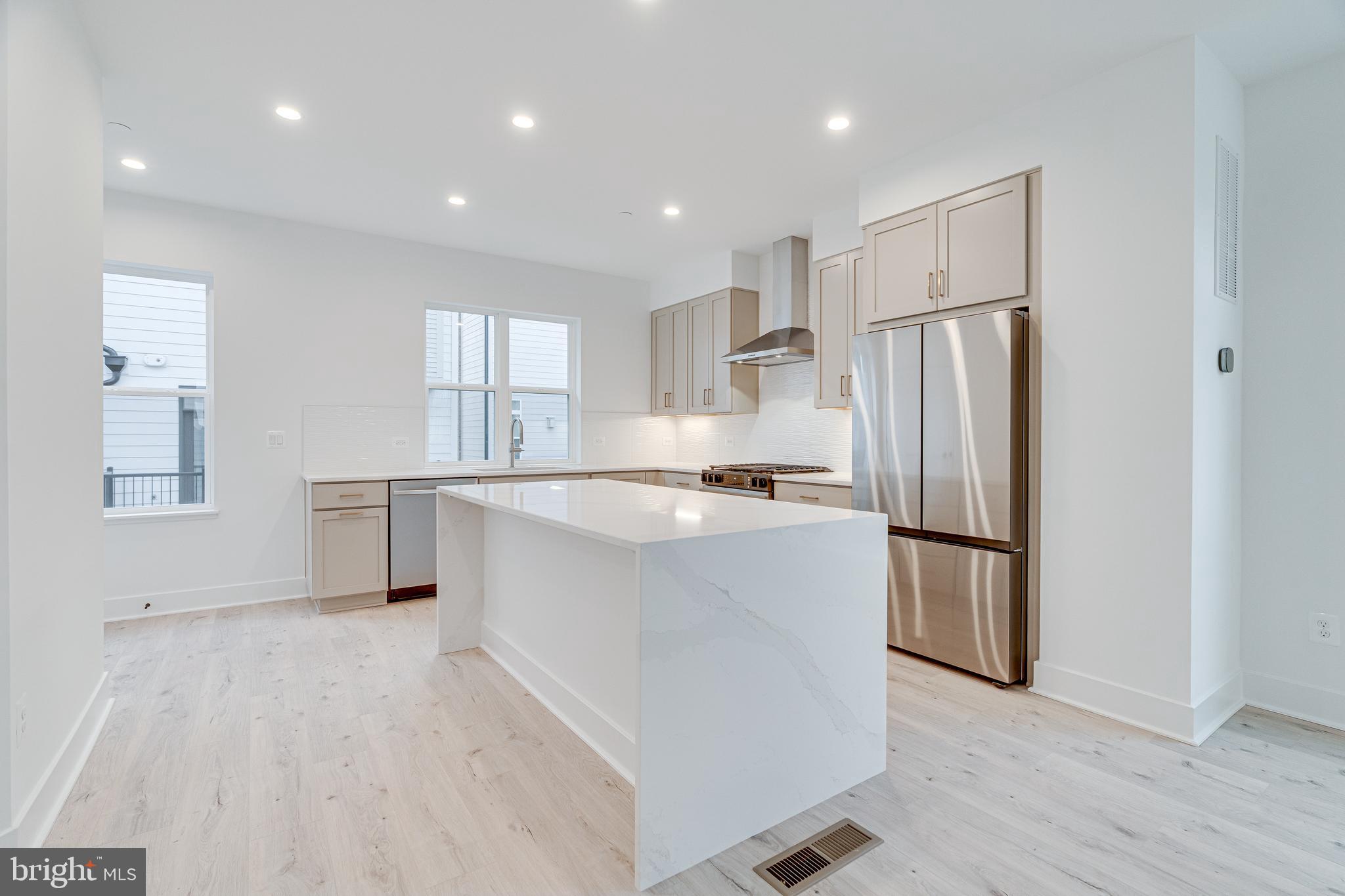 2070 Tysons Ridgeline Road Falls Church, VA 22043 - Photo 22 of 57 a kitchen with refrigerator cabinets and wooden floor