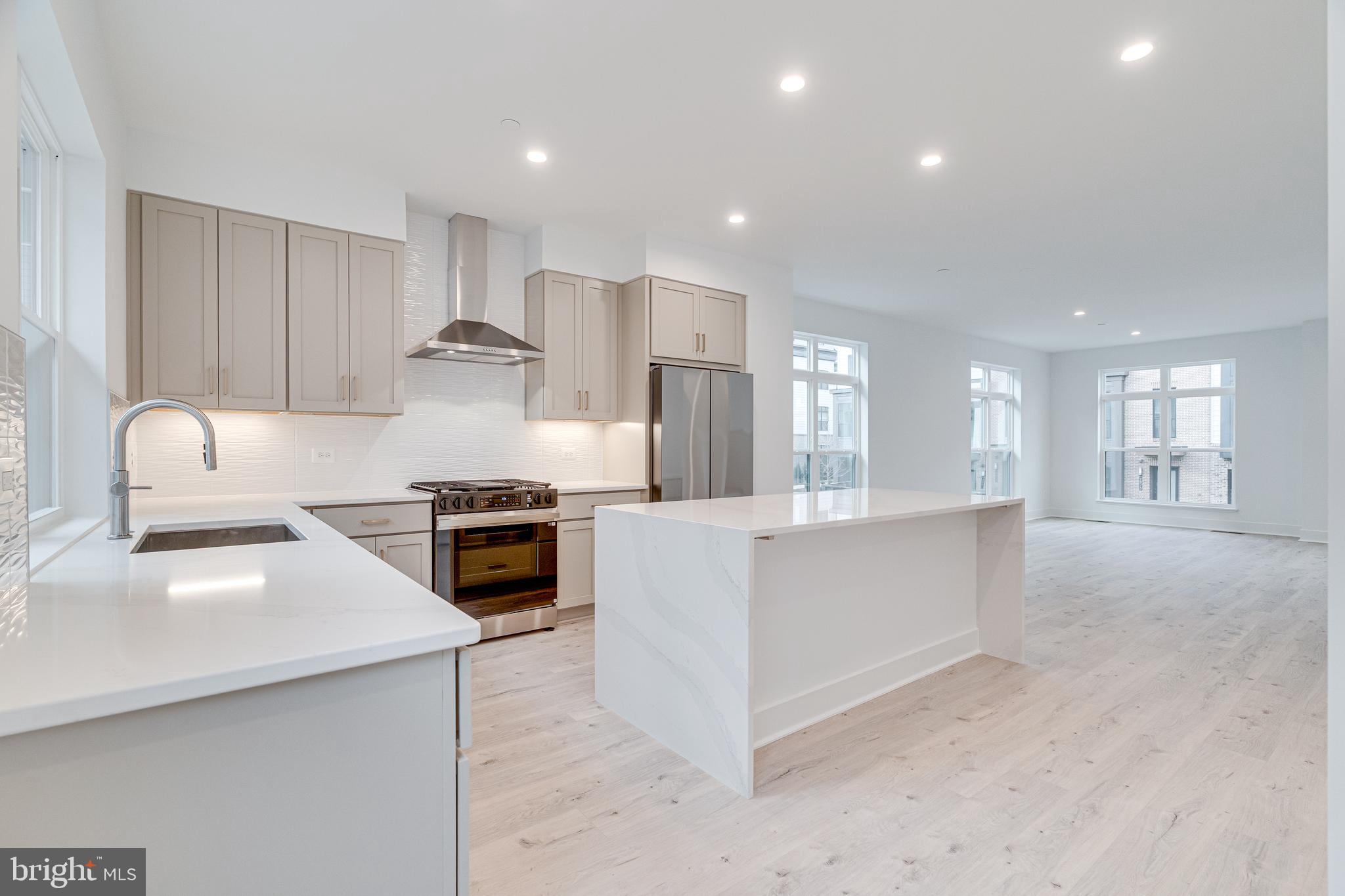 2070 Tysons Ridgeline Road Falls Church, VA 22043 - Photo 23 of 57 a kitchen with stainless steel appliances granite countertop a stove a sink and a refrigerator