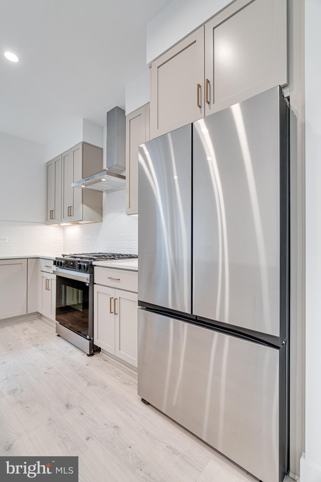 2070 Tysons Ridgeline Road Falls Church, VA 22043 - Photo 25 of 57 a kitchen with stainless steel appliances a refrigerator sink and cabinets