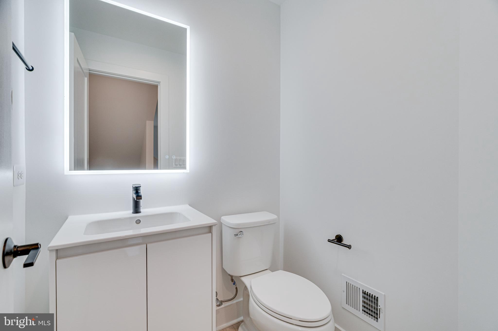 2070 Tysons Ridgeline Road Falls Church, VA 22043 - Photo 30 of 57 a bathroom with a toilet sink and mirror