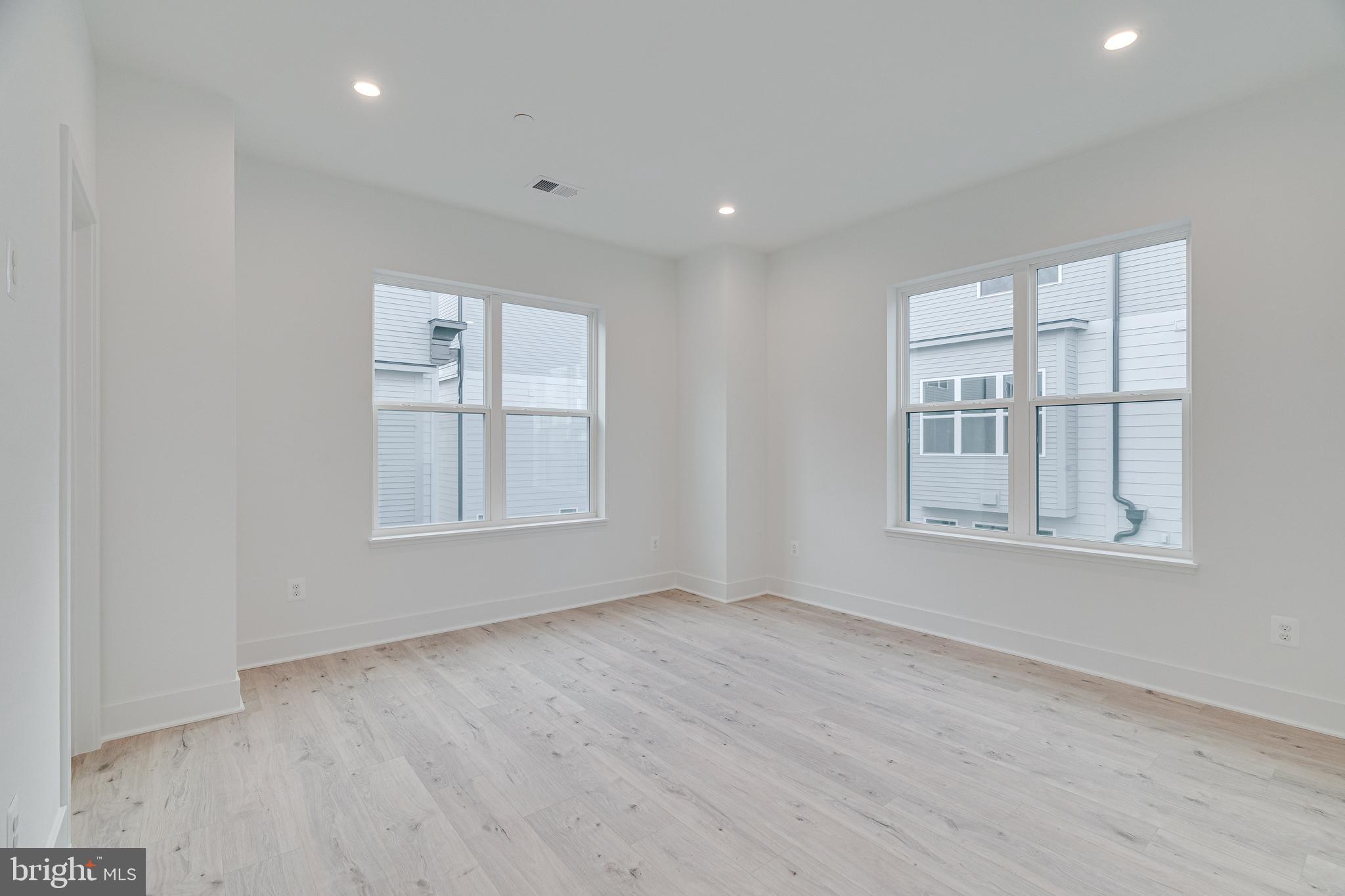 2070 Tysons Ridgeline Road Falls Church, VA 22043 - Photo 33 of 57 an empty room with wooden floor and windows