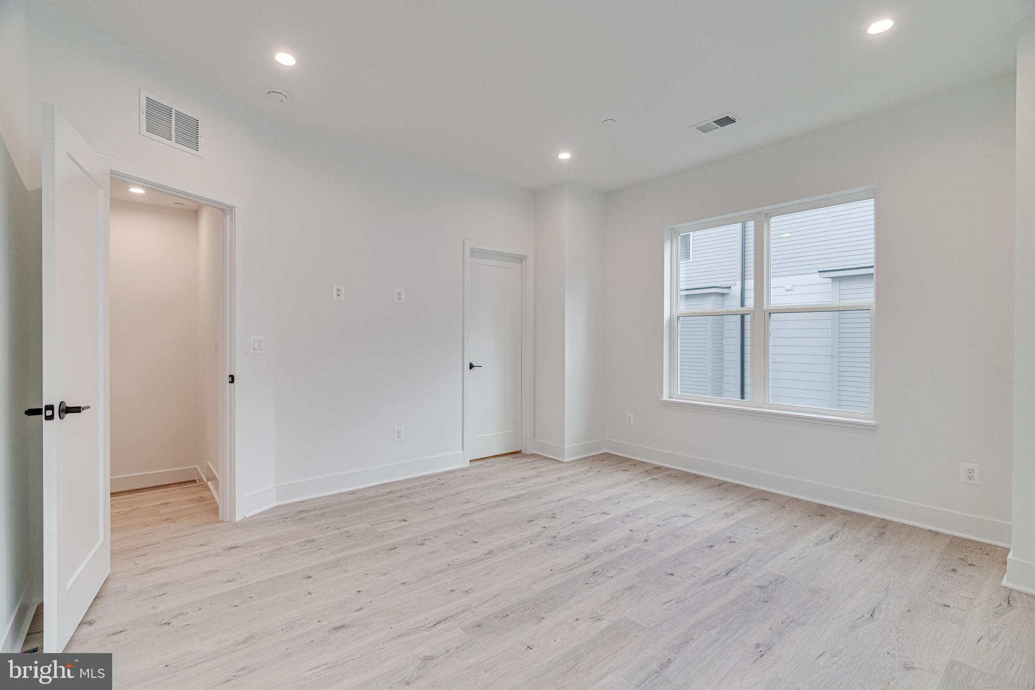 2070 Tysons Ridgeline Road Falls Church, VA 22043 - Photo 35 of 57 an empty room with wooden floor and windows