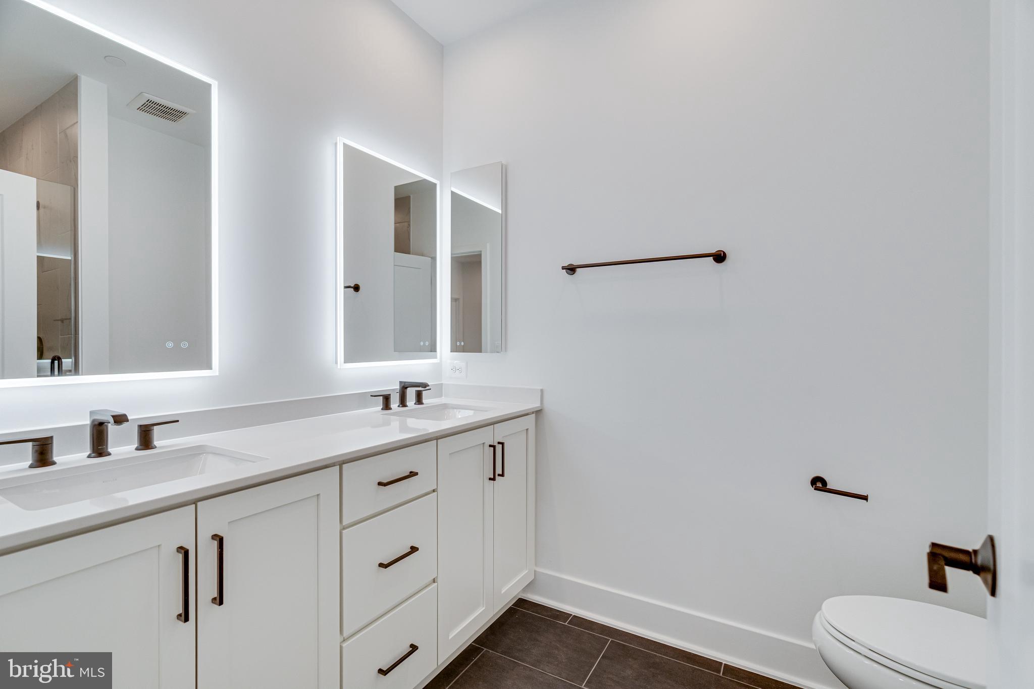2070 Tysons Ridgeline Road Falls Church, VA 22043 - Photo 36 of 57 a bathroom with a granite countertop sink vanity mirror and toilet