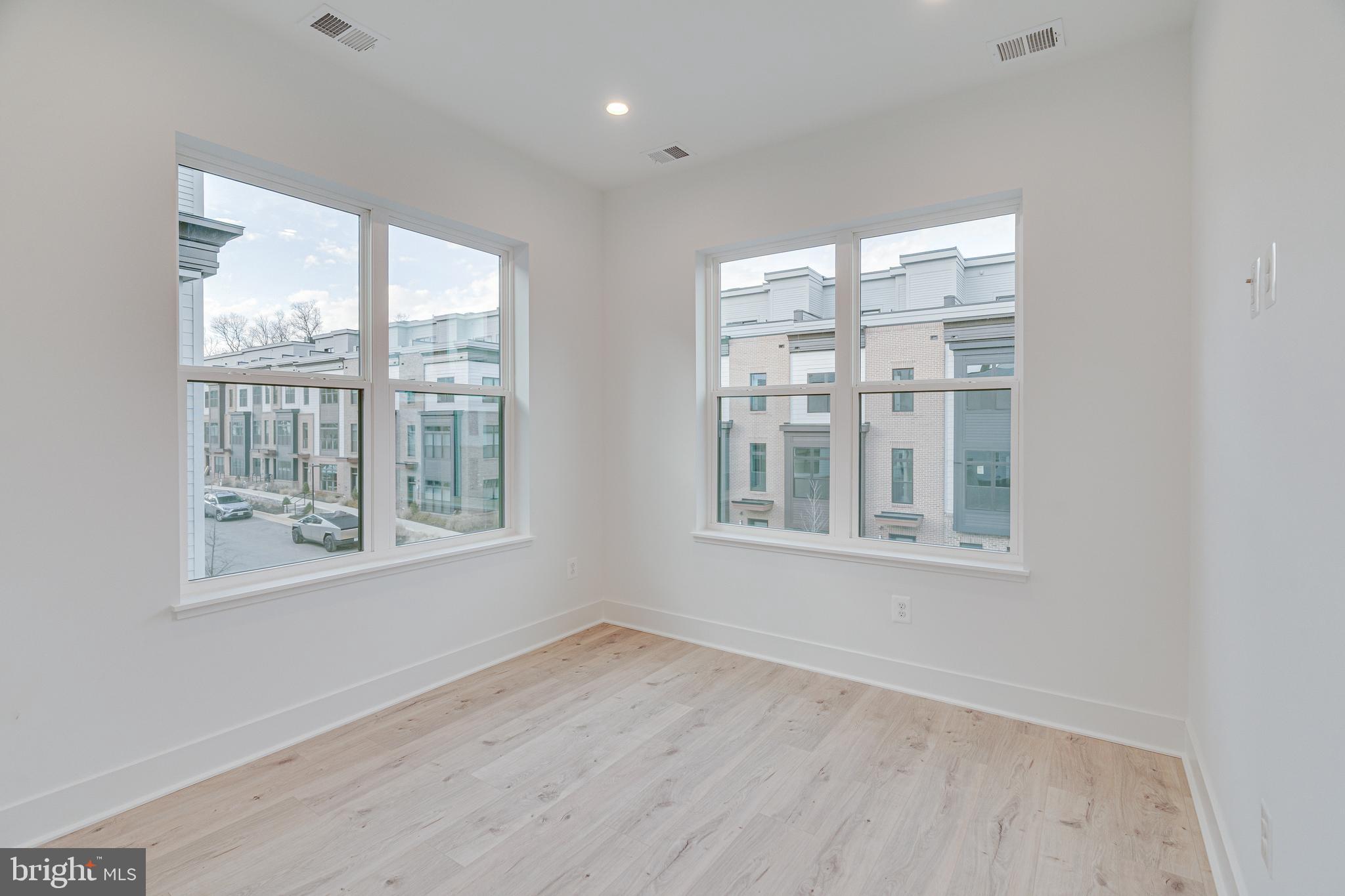 2070 Tysons Ridgeline Road Falls Church, VA 22043 - Photo 39 of 57 a view of an empty room with a window and wooden floor