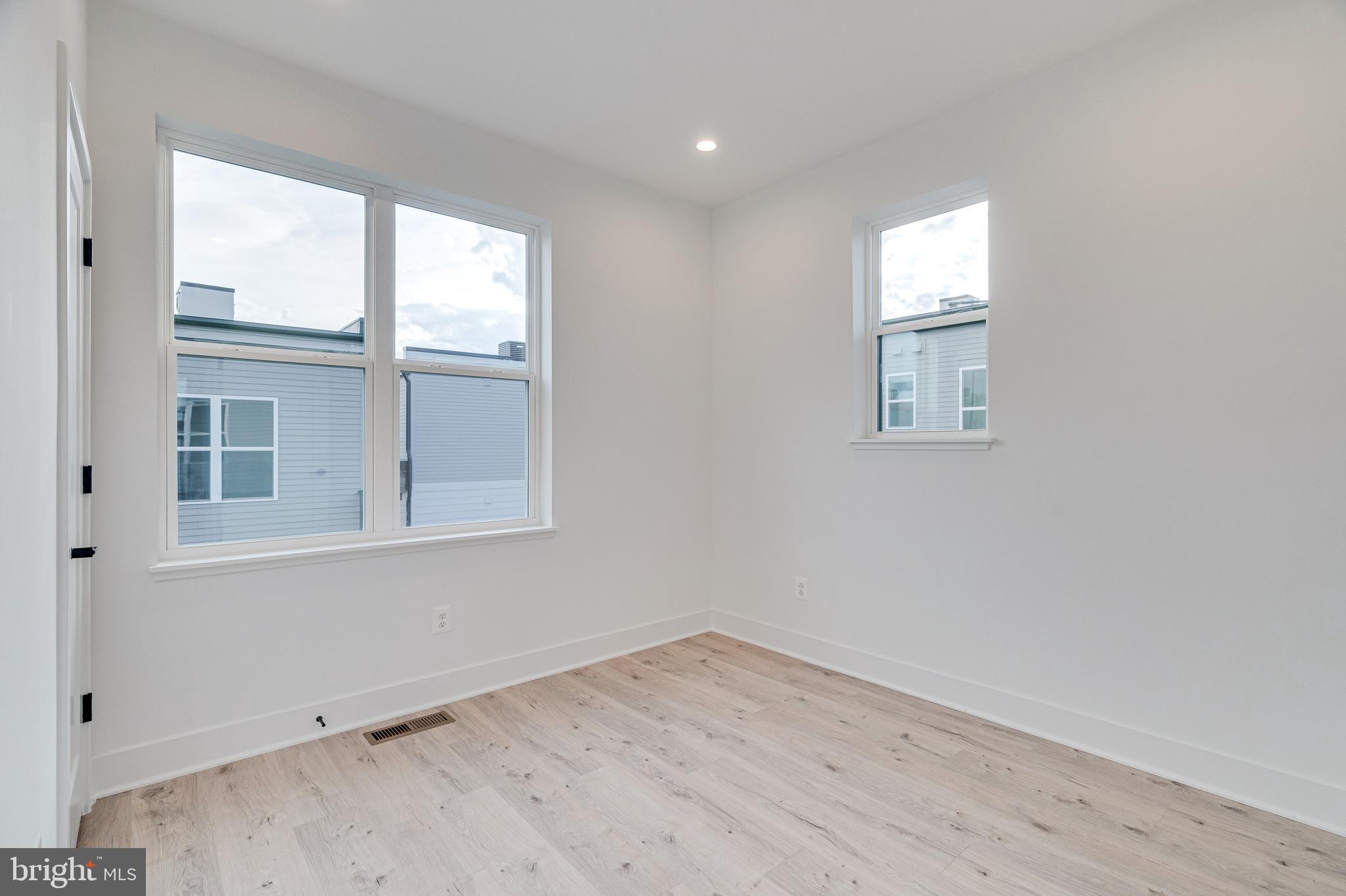 2070 Tysons Ridgeline Road Falls Church, VA 22043 - Photo 43 of 57 an empty room with wooden floor and windows