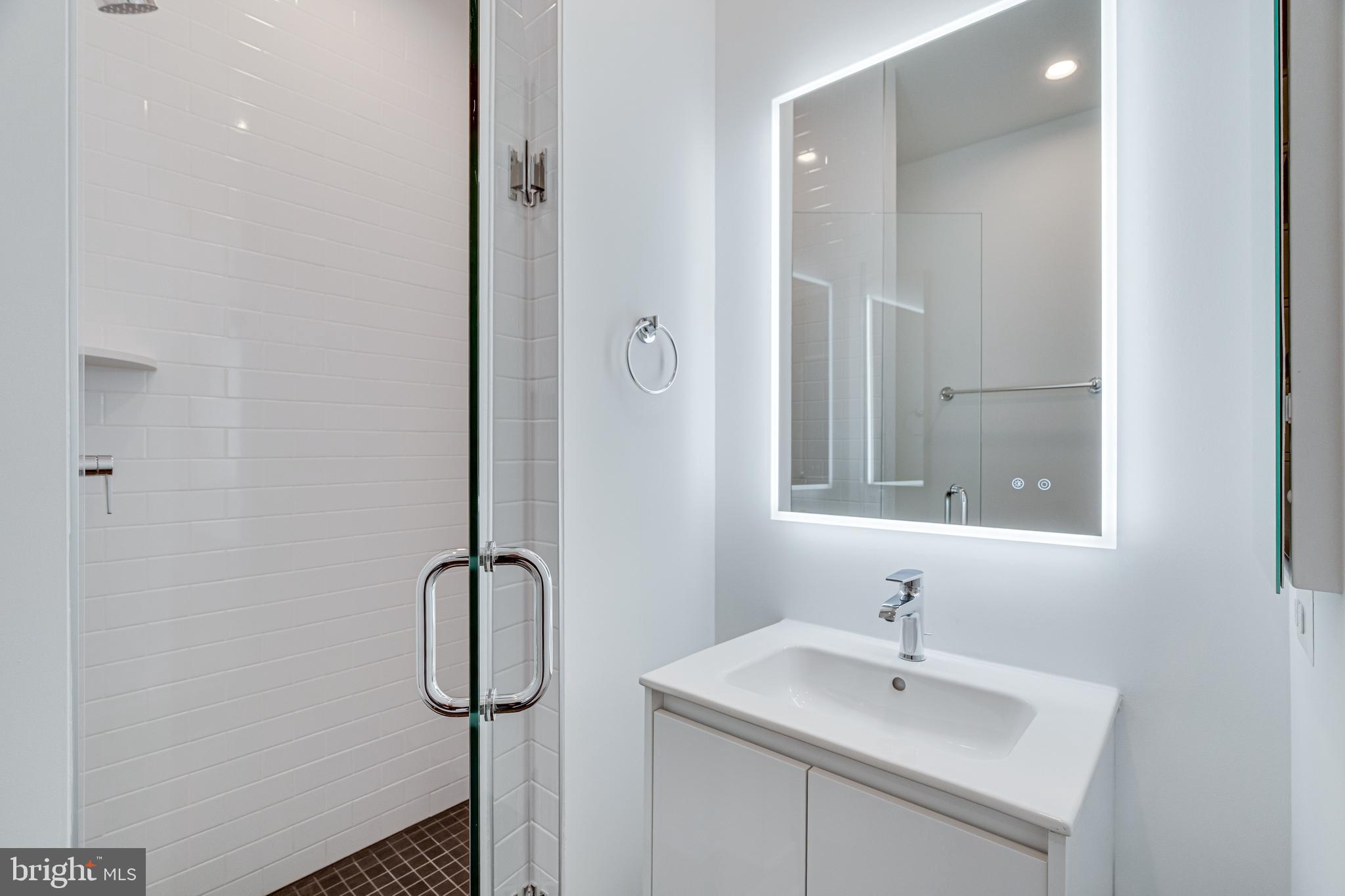 2070 Tysons Ridgeline Road Falls Church, VA 22043 - Photo 50 of 57 a bathroom with a sink and mirror
