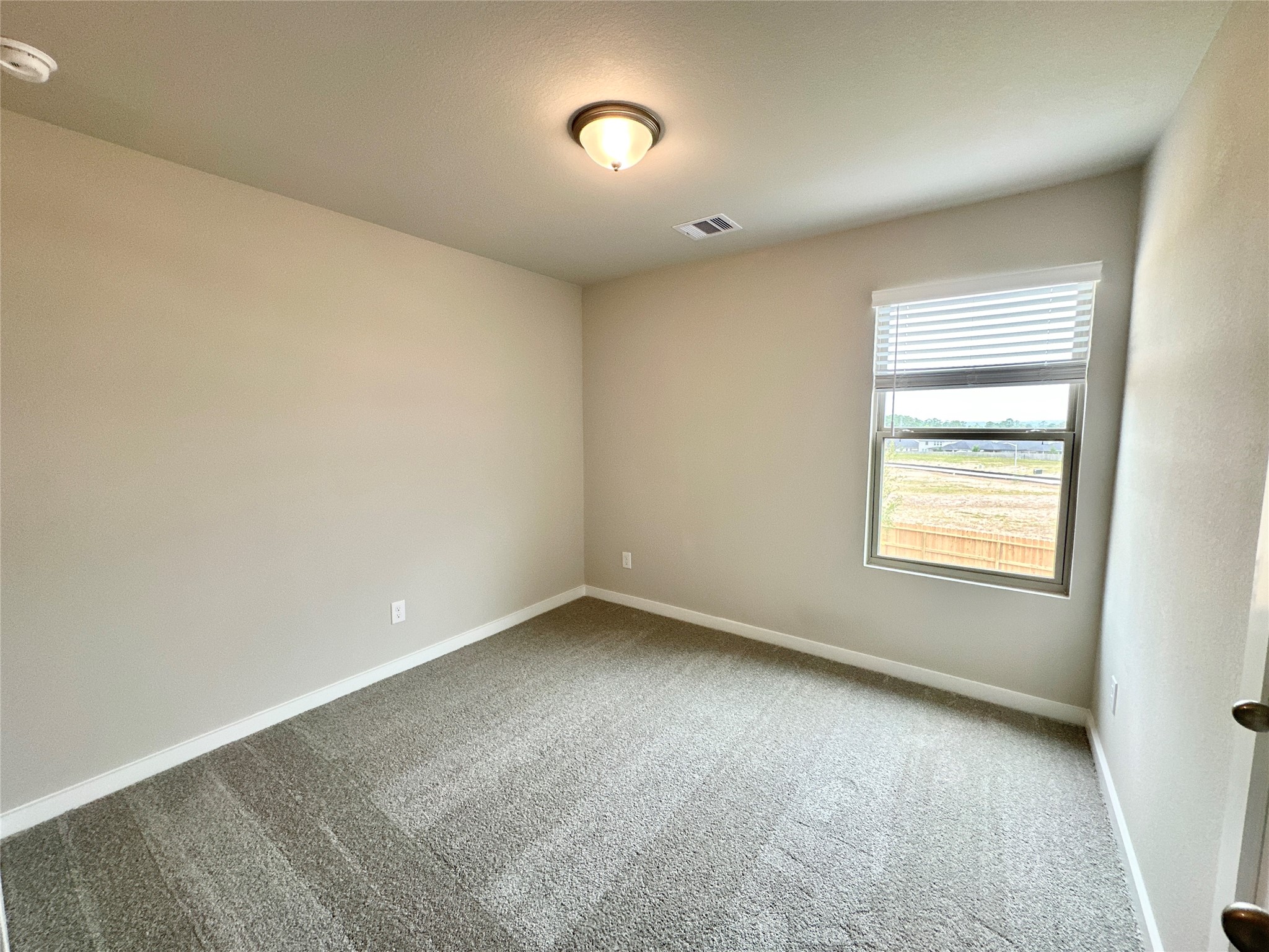 12198 Ridge Top Drive Conroe, TX 77304 - Photo 14 of 27 an empty room with a window