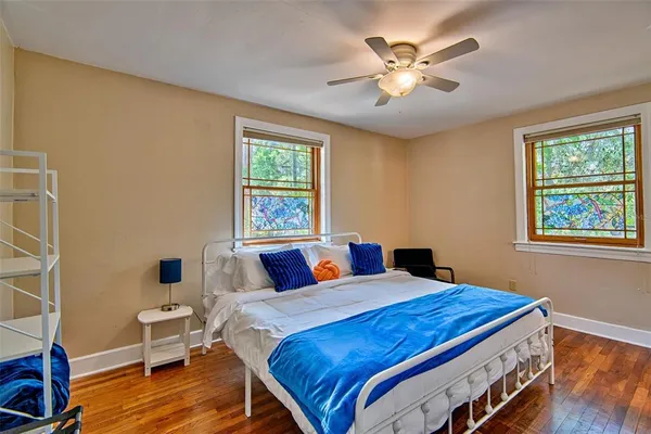 a bedroom with a bed and a chandelier