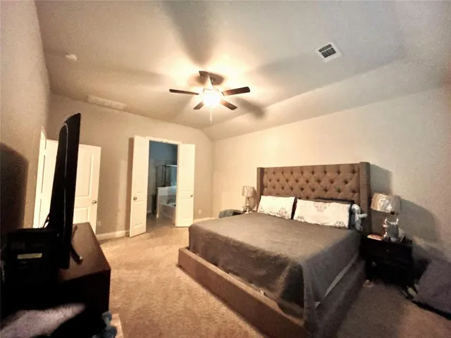 a bedroom with a bed and a flat screen tv