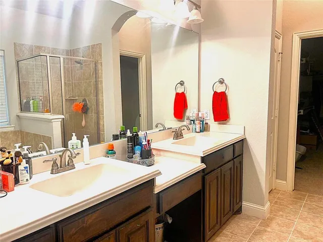 a bedroom with a bed ceiling fan and a window