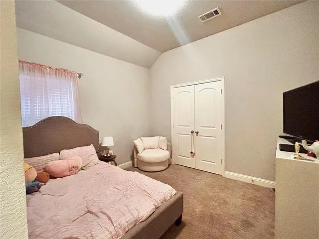 a large kitchen with kitchen island granite countertop a stove top oven a sink a counter top space and cabinets