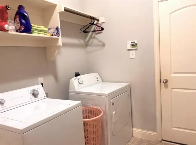 a kitchen with stainless steel appliances kitchen island granite countertop a refrigerator a stove top oven and a sink with granite countertops