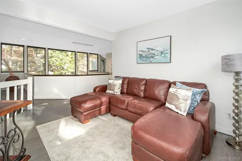 a room with a bed and large windows