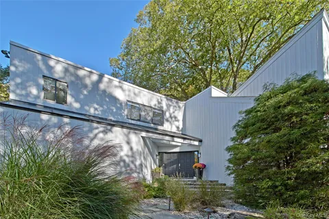 a green field with trees in front of it