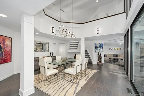 a view of a hallway with wooden floor and furniture