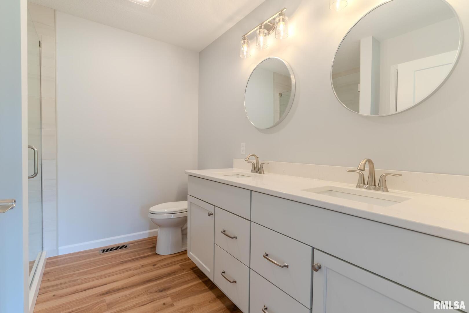 941 9th Avenue North Clinton, IA 52732 - Photo 11 of 24 a spacious bathroom with a double vanity sink mirror and toilet