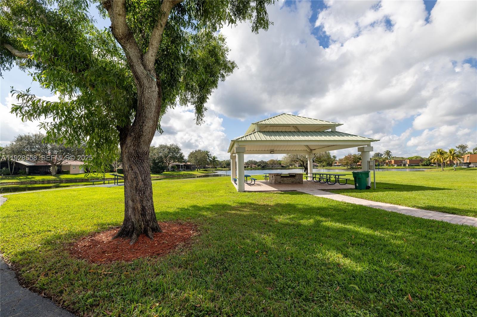 11006 North Harmony Lake Circle Davie, FL 33324 - Photo 16 of 46 a view of a house with a big yard and large trees