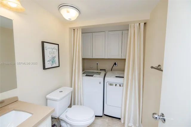 a white toilet sitting next to a bathroom sink