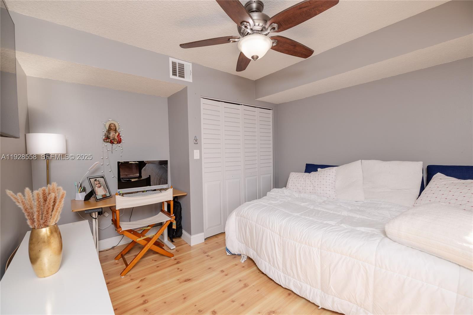 11006 North Harmony Lake Circle Davie, FL 33324 - Photo 24 of 46 a bedroom with a bed and a chandelier