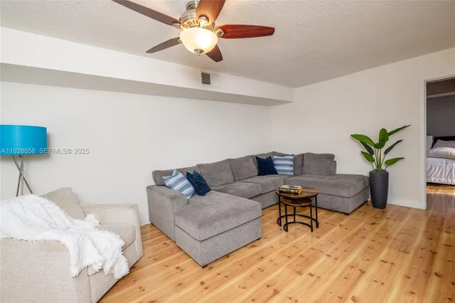 a living room with furniture and a lamp