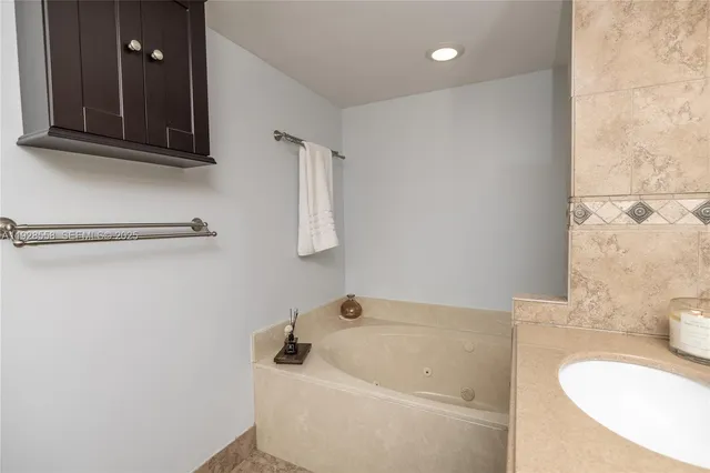 a bathroom with a tub a sink and a toilet