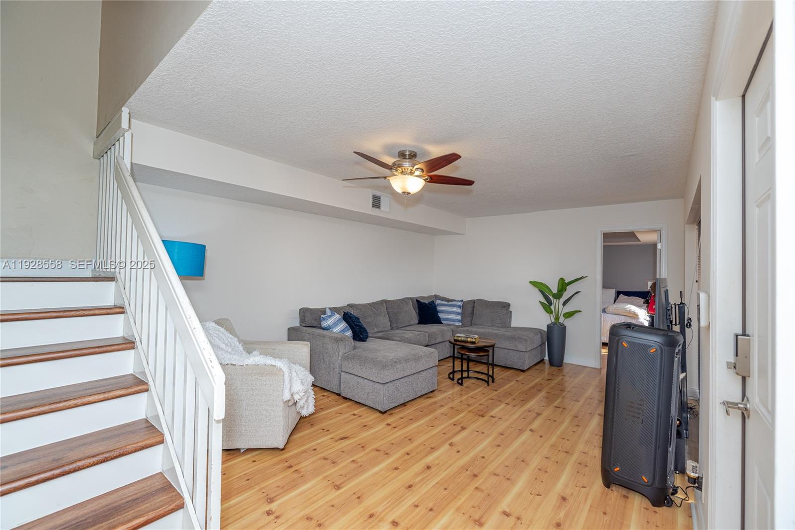 11006 North Harmony Lake Circle Davie, FL 33324 - Photo 4 of 46 a living room with furniture and a chandelier