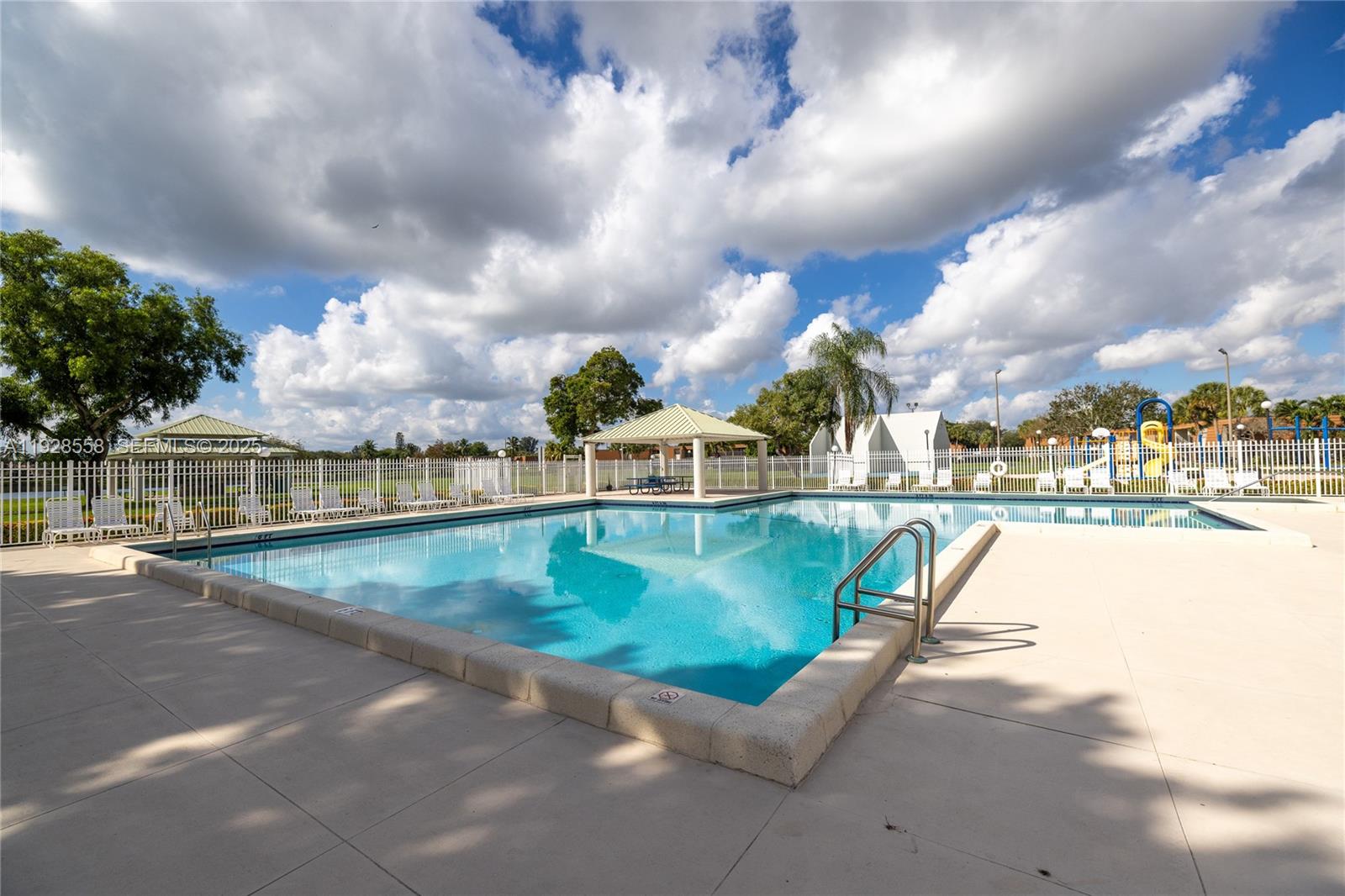 11006 North Harmony Lake Circle Davie, FL 33324 - Photo 41 of 46 a view of swimming pool with outdoor seating and barbeque oven