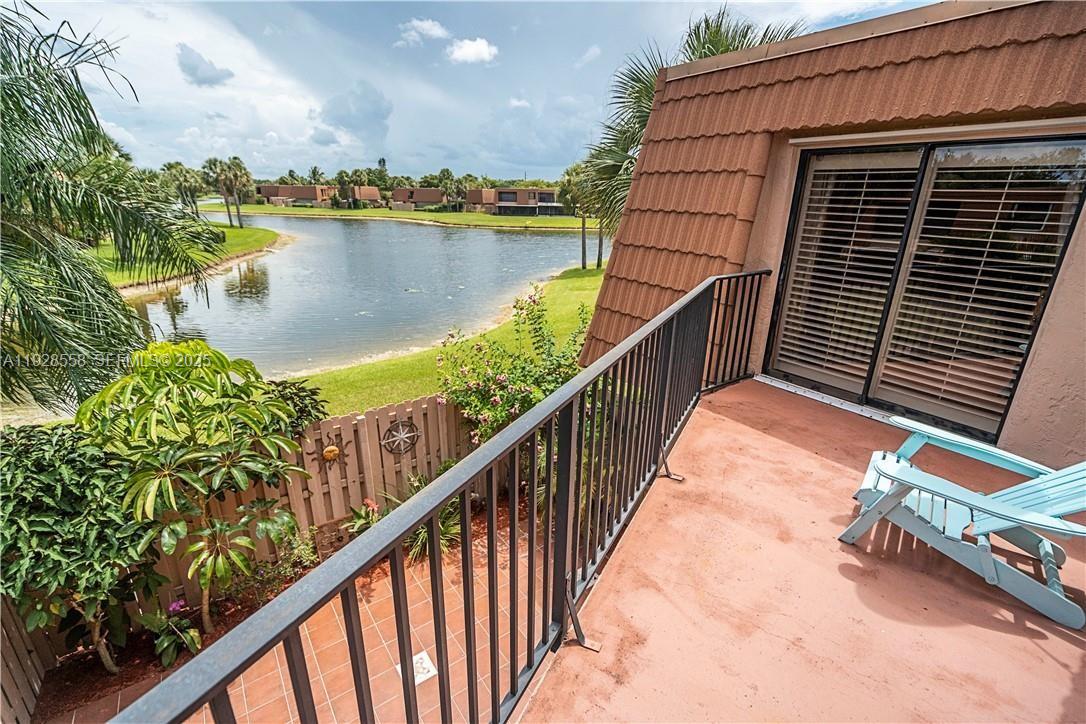 11006 North Harmony Lake Circle Davie, FL 33324 - Photo 46 of 46 a balcony with wooden floor and lake view