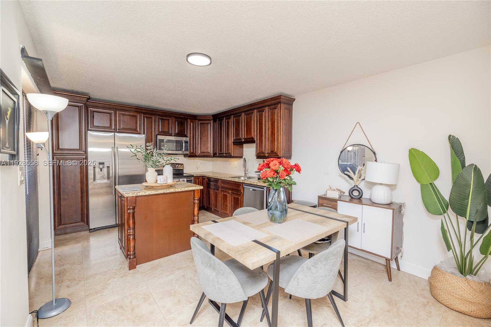 11006 North Harmony Lake Circle Davie, FL 33324 - Photo 8 of 46 a dining room filled chandelier and kitchen view