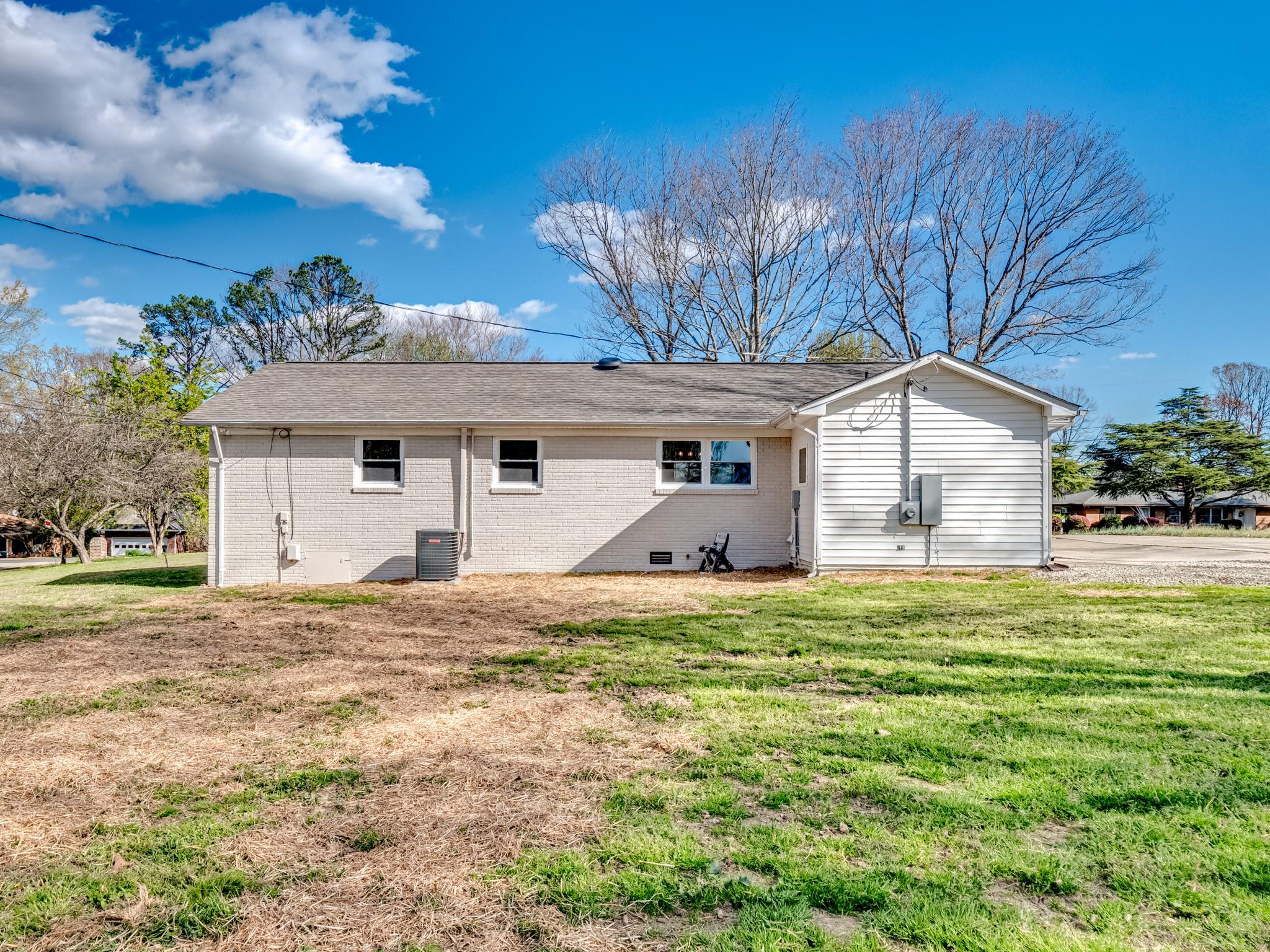 1813 Timber Ln Drive Monroe, NC 28110 - Photo 11 of 35 a big house with a big yard and large trees