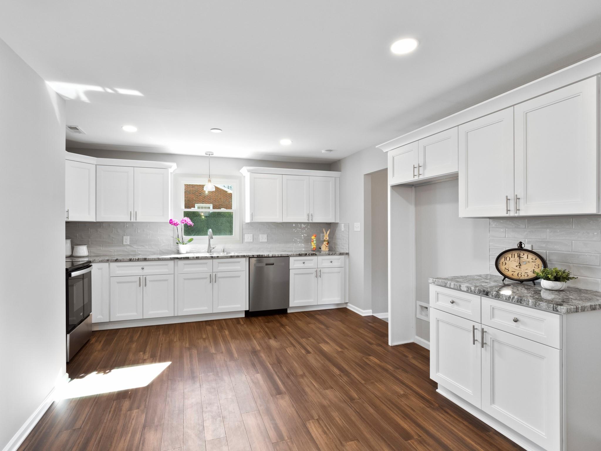 1813 Timber Ln Drive Monroe, NC 28110 - Photo 14 of 35 a kitchen with granite countertop white cabinets and white appliances