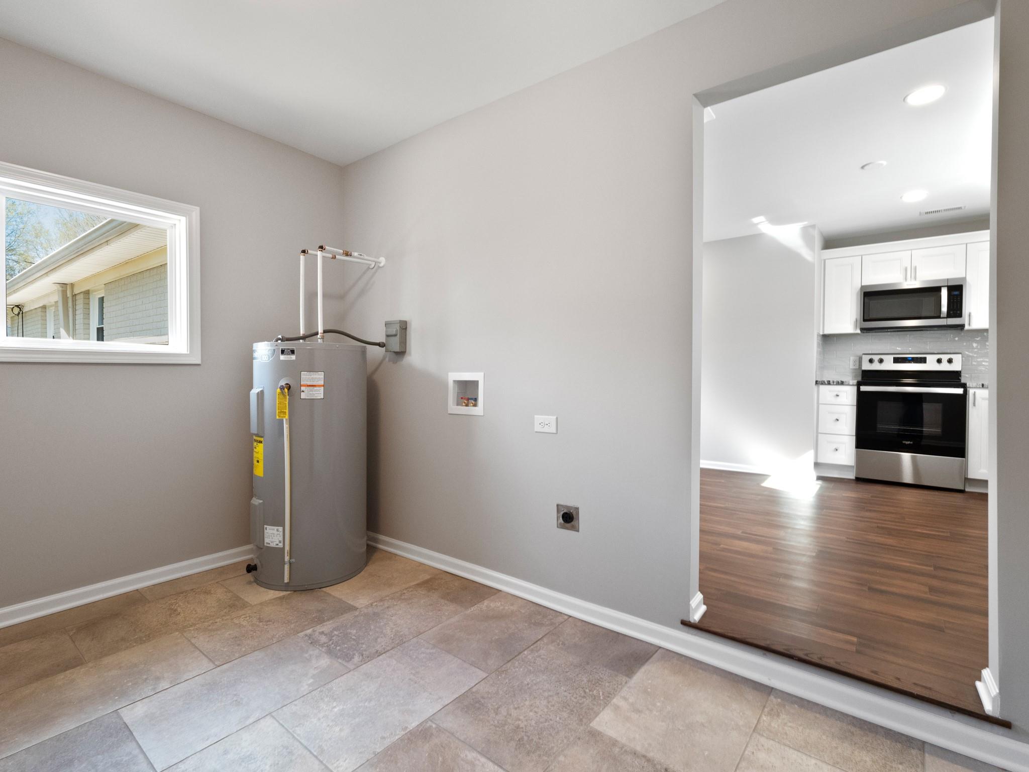 1813 Timber Ln Drive Monroe, NC 28110 - Photo 18 of 35 a view of a kitchen with refrigerator and wooden floor