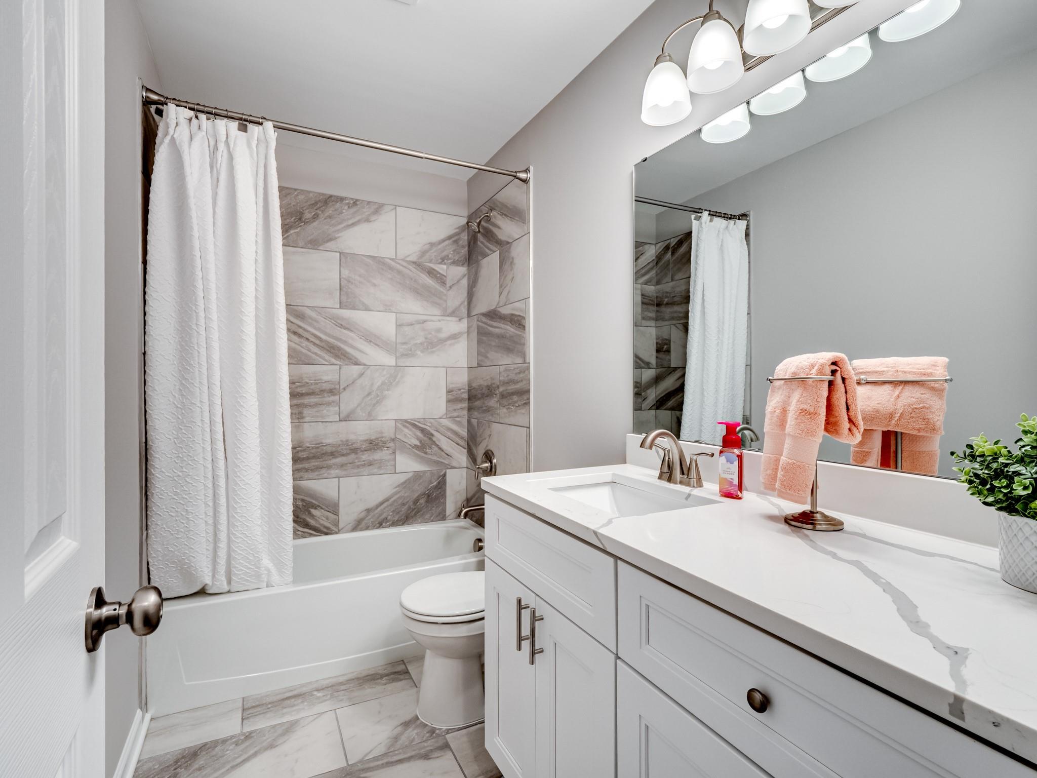 1813 Timber Ln Drive Monroe, NC 28110 - Photo 20 of 35 a bathroom with a sink a toilet a mirror and shower