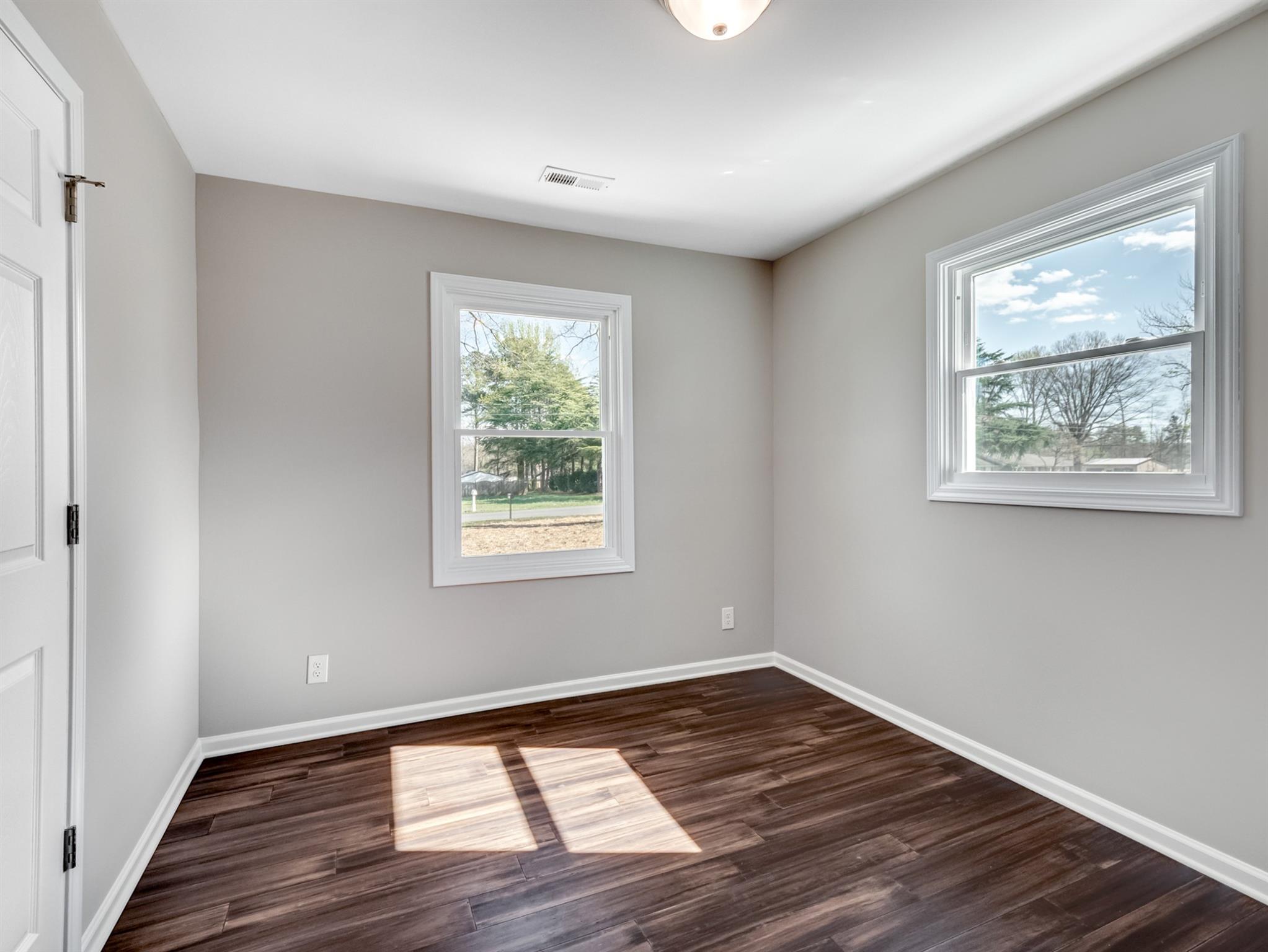 1813 Timber Ln Drive Monroe, NC 28110 - Photo 21 of 35 a view of an empty room with wooden floor and a window